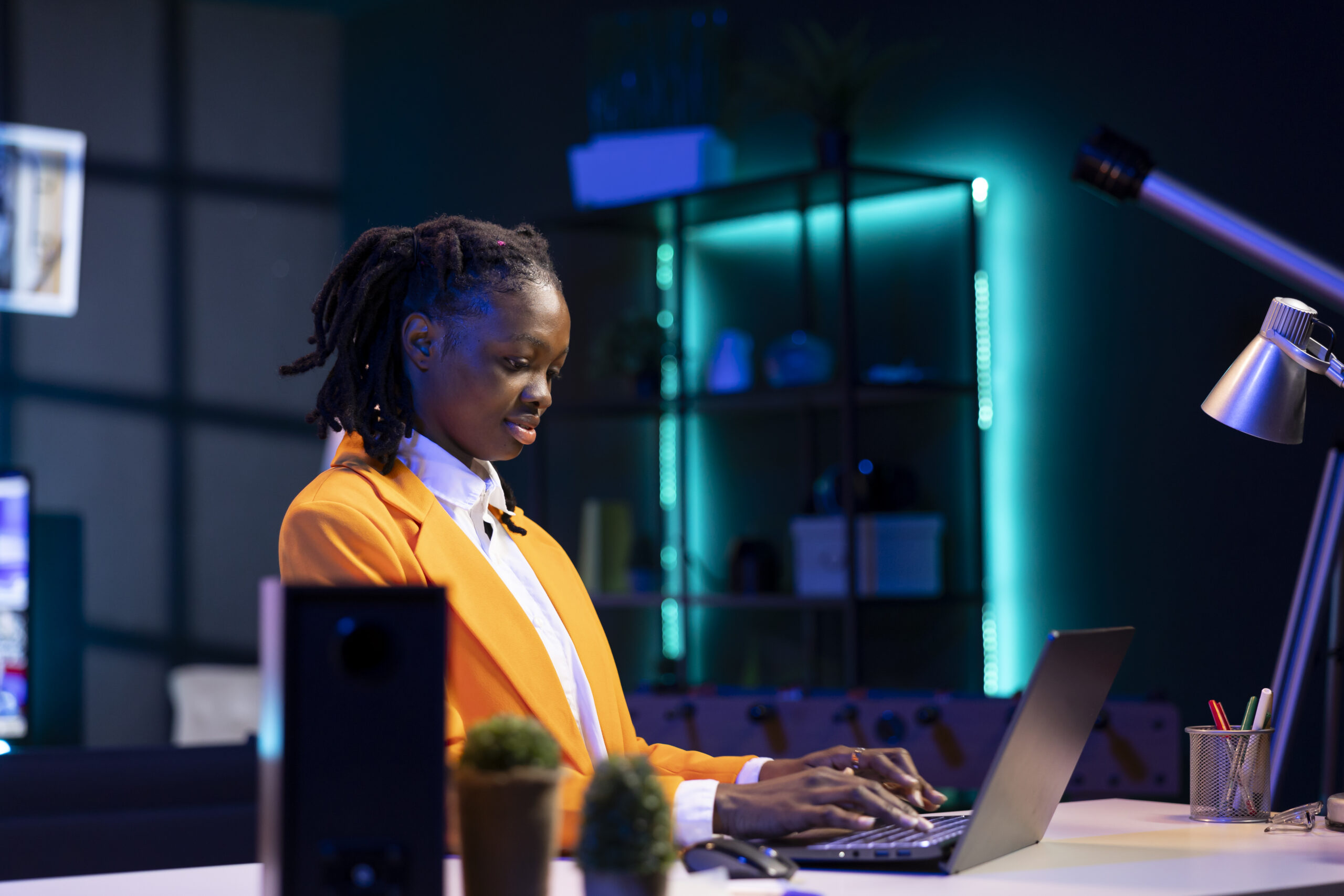 Freelancer in home office sitting at desk and typing on laptop keyboard. Remote employee using electronic device to do customers relations job online, answering inquiries